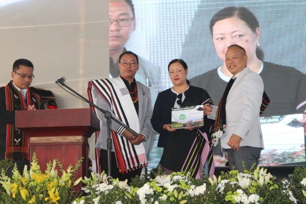 Minister Salhoutuonuo Kruse releasing 75th anniversary souvenir of Kigwema Students’ Union at Kigwema Village on December 30. (Morung Photo)